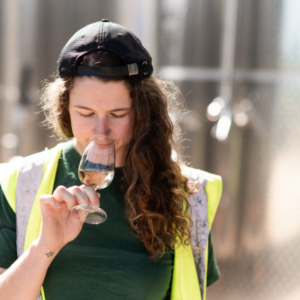 lyme bay winery winemaker smelling a glass of wine