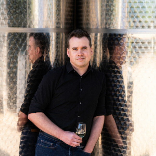 James Lambert holding a glass of wine