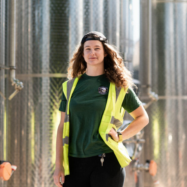 Sarah Massey in front of wine vats