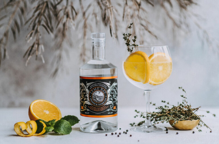 lyme bay winery orange and thyme gin bottle with spices and fruits